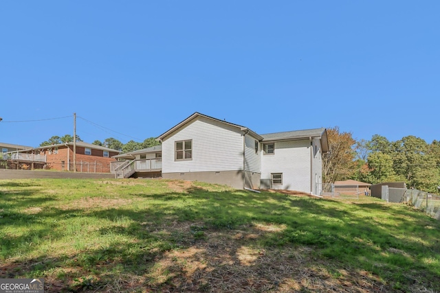 rear view of house featuring a lawn