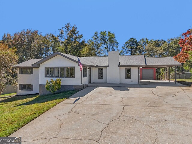 ranch-style home with a carport and a front lawn