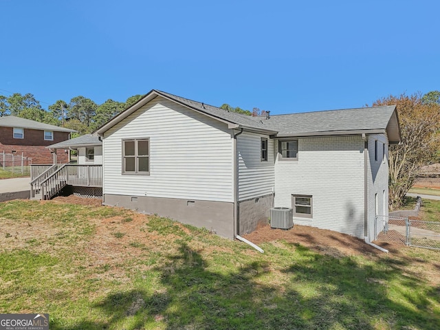 view of side of property featuring a lawn and cooling unit