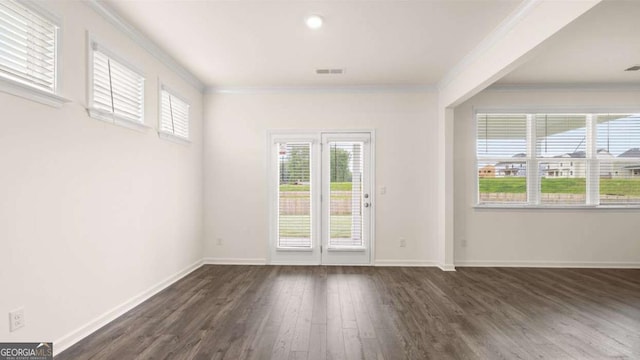 spare room with crown molding and dark hardwood / wood-style floors