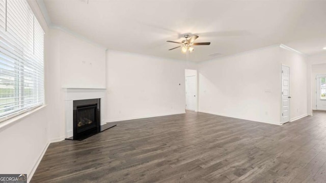 unfurnished living room with ceiling fan, dark hardwood / wood-style floors, and crown molding