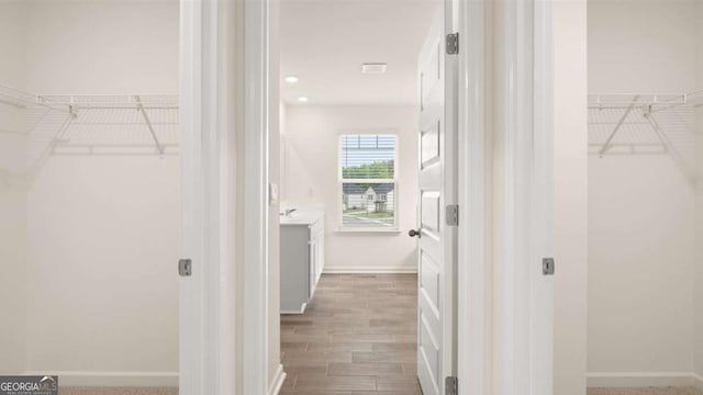 spacious closet featuring hardwood / wood-style flooring