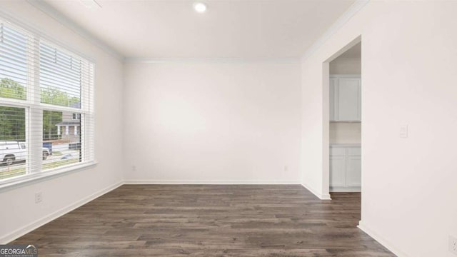 unfurnished room with dark hardwood / wood-style flooring and crown molding