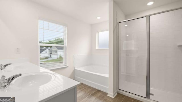 bathroom with vanity and independent shower and bath