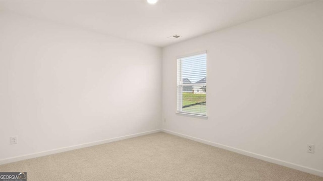 spare room featuring carpet floors