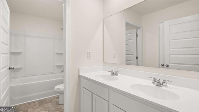 full bathroom with vanity, shower / bathtub combination, and toilet