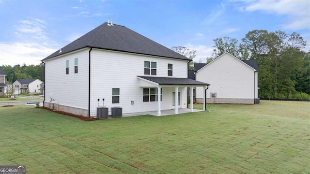 back of property with a patio, central AC unit, and a lawn