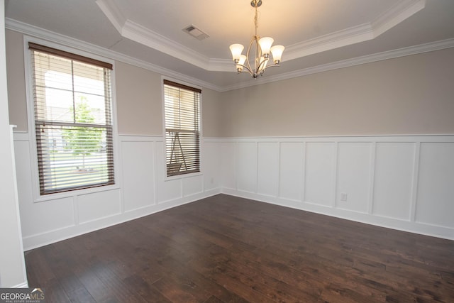 unfurnished room with a chandelier, dark wood-type flooring, crown molding, and a tray ceiling