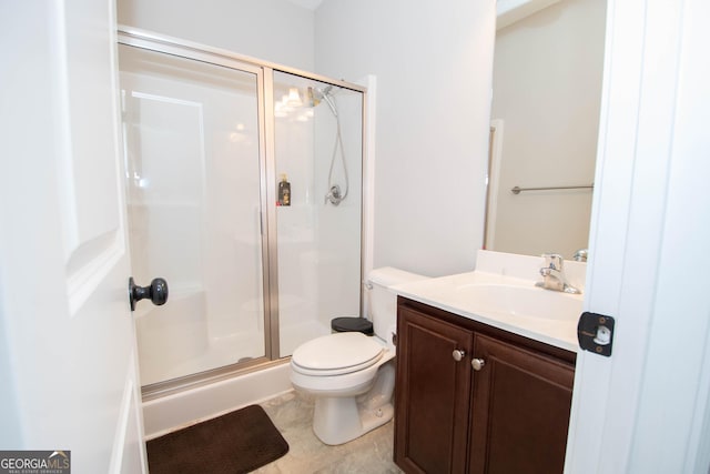 bathroom with vanity, toilet, and walk in shower