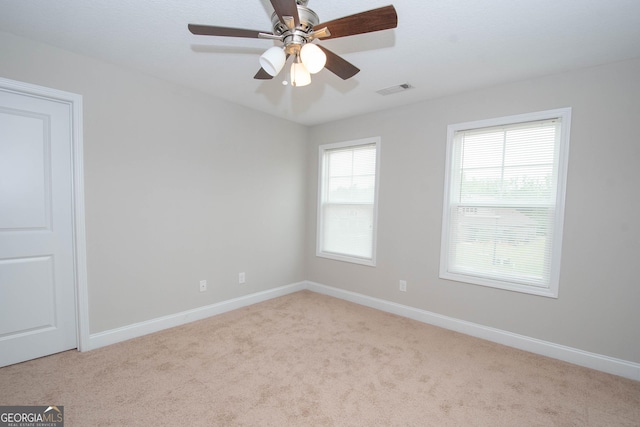 carpeted empty room with ceiling fan