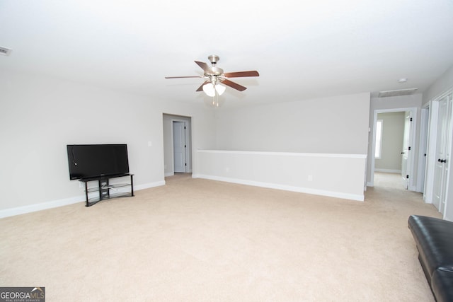 carpeted living room with ceiling fan