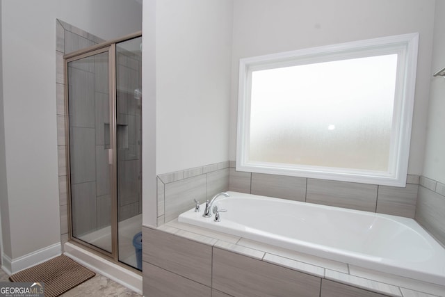 bathroom featuring separate shower and tub