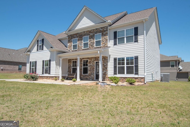 view of front of home featuring a front yard and central air condition unit