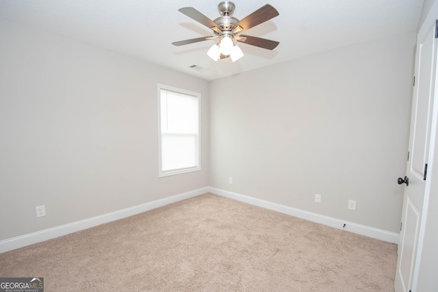 spare room featuring ceiling fan and light carpet