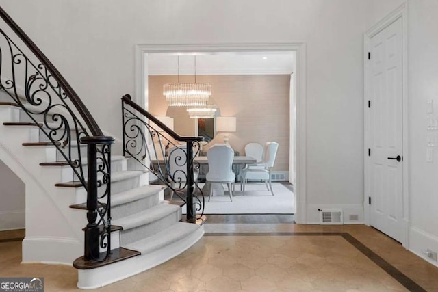 foyer entrance with a notable chandelier