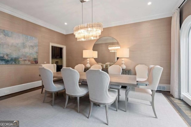 dining area with a notable chandelier and crown molding