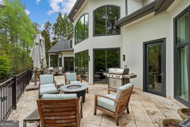 view of patio with grilling area and a fire pit