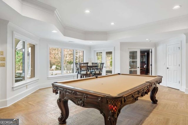 recreation room featuring a tray ceiling, light parquet floors, plenty of natural light, and crown molding