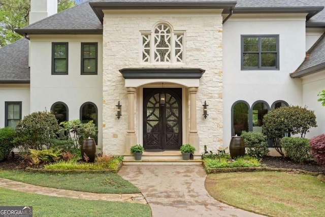 doorway to property featuring a lawn