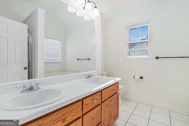 bathroom with tile patterned floors, vanity, vaulted ceiling, and toilet