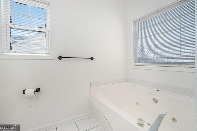 bathroom with a bath and tile patterned floors