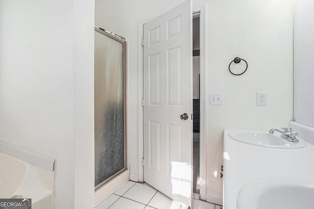 bathroom with tile patterned floors, vanity, and a shower with door