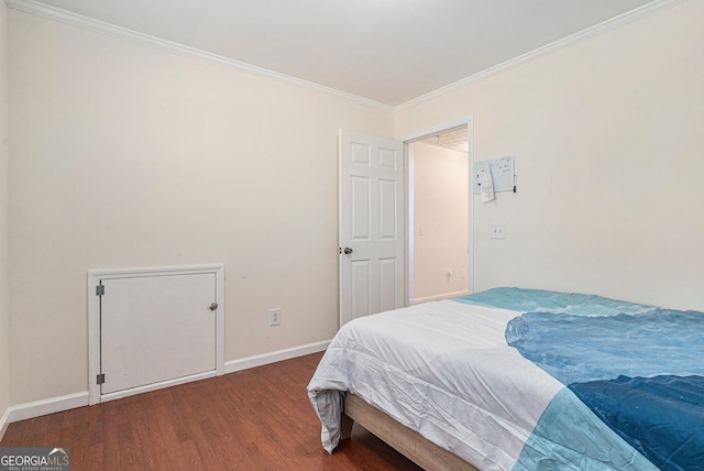 bedroom with dark hardwood / wood-style floors and crown molding