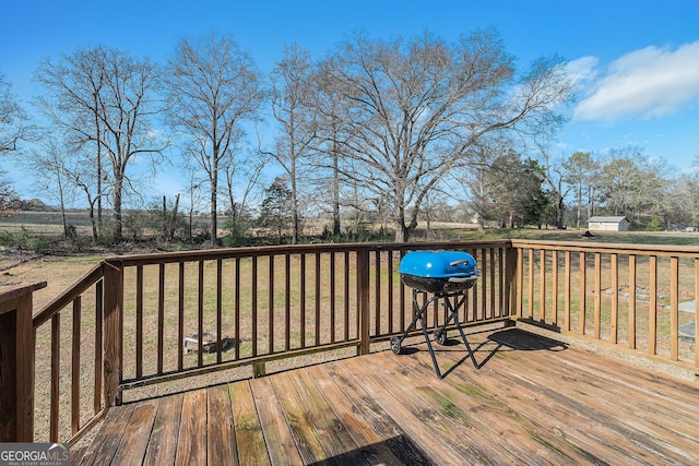 deck with grilling area and a lawn