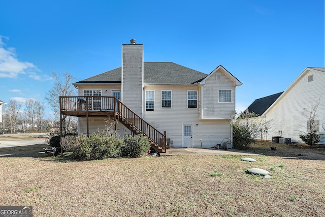 rear view of property featuring a deck, cooling unit, a patio area, and a lawn