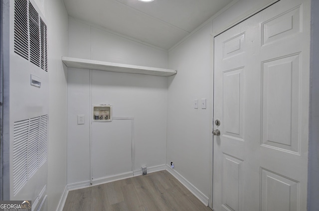 laundry room featuring washer hookup and light hardwood / wood-style floors