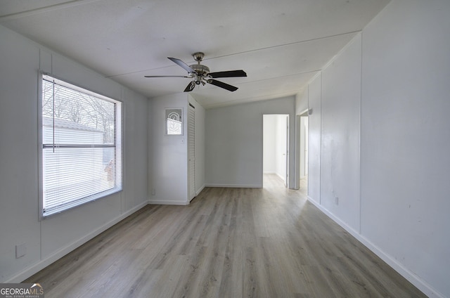 unfurnished room with light hardwood / wood-style floors, ceiling fan, and lofted ceiling