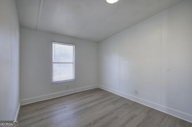 spare room featuring light hardwood / wood-style floors