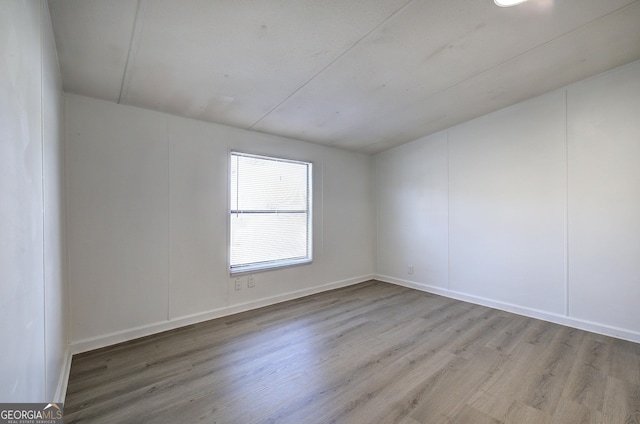 spare room featuring light wood-type flooring