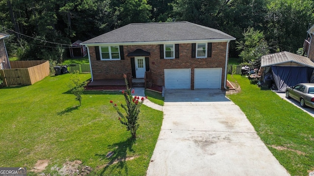 raised ranch featuring a front lawn and a garage