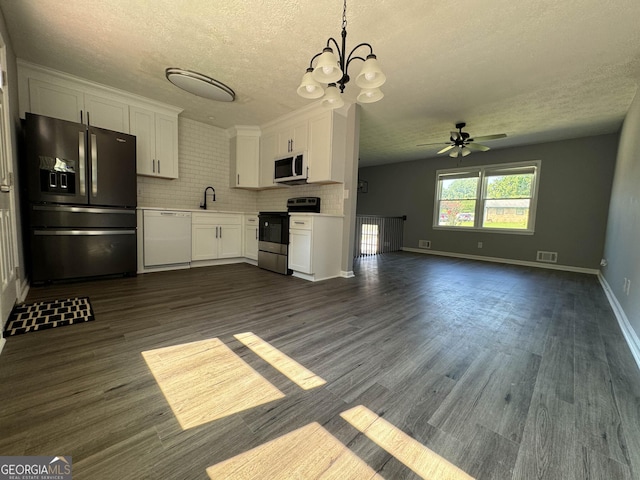 kitchen with white cabinetry, sink, ceiling fan with notable chandelier, and white appliances