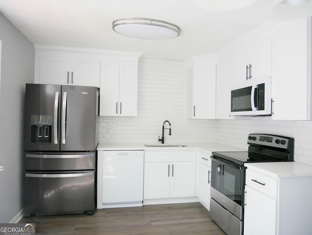 kitchen with white cabinets, stainless steel appliances, tasteful backsplash, and sink