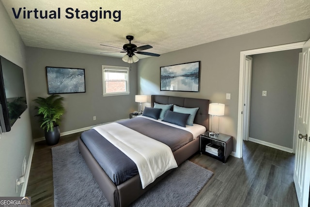 bedroom with ceiling fan, dark hardwood / wood-style flooring, and a textured ceiling