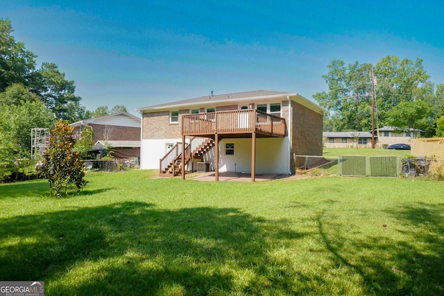 rear view of house featuring a lawn, a patio area, and a wooden deck