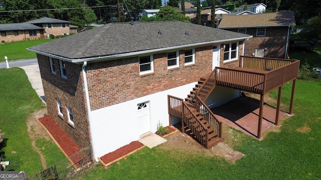 back of house featuring a lawn, a patio area, and a deck