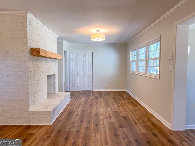 interior space with ornamental molding, a fireplace, and dark hardwood / wood-style flooring