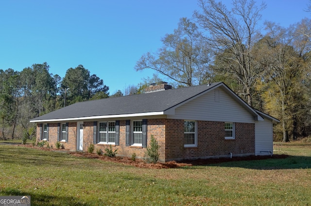 view of side of property with a lawn