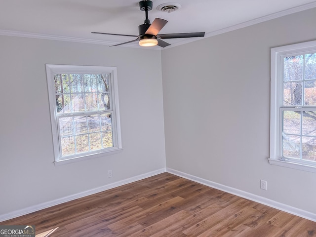 spare room featuring hardwood / wood-style flooring, crown molding, and ceiling fan