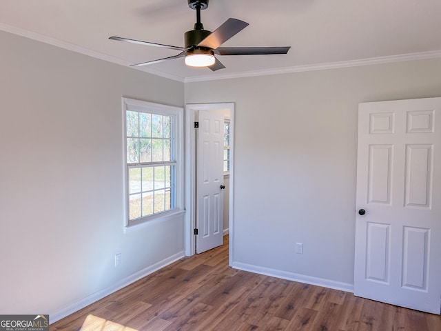 unfurnished room featuring ceiling fan, crown molding, and hardwood / wood-style flooring