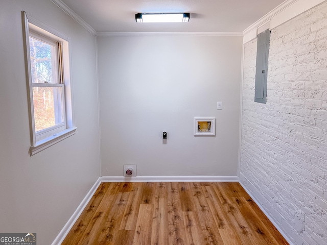 laundry area with crown molding, washer hookup, brick wall, and hookup for an electric dryer