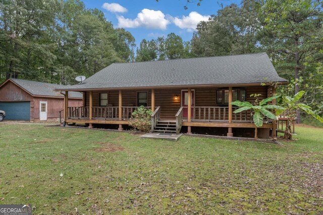 cabin featuring covered porch and a front lawn