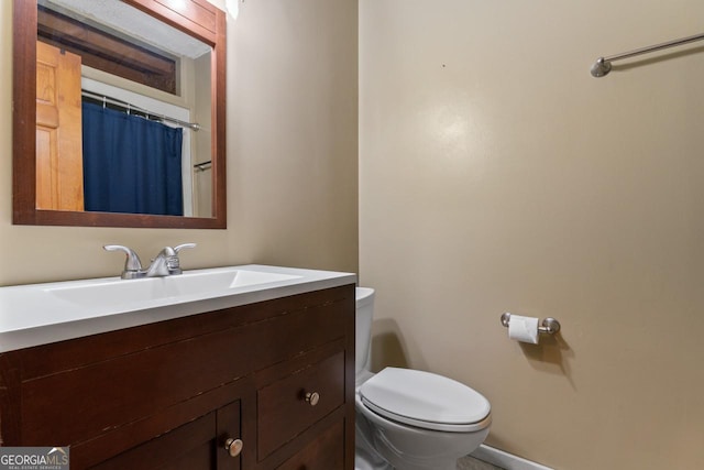 bathroom with vanity, walk in shower, and toilet