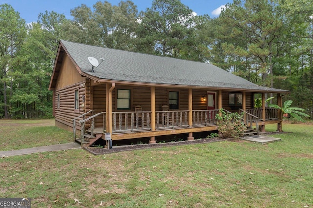 cabin with a porch and a front lawn