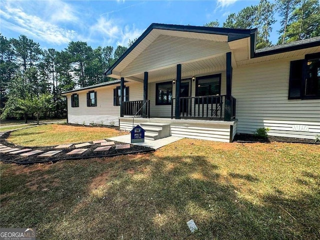 view of front of property with covered porch and a front yard