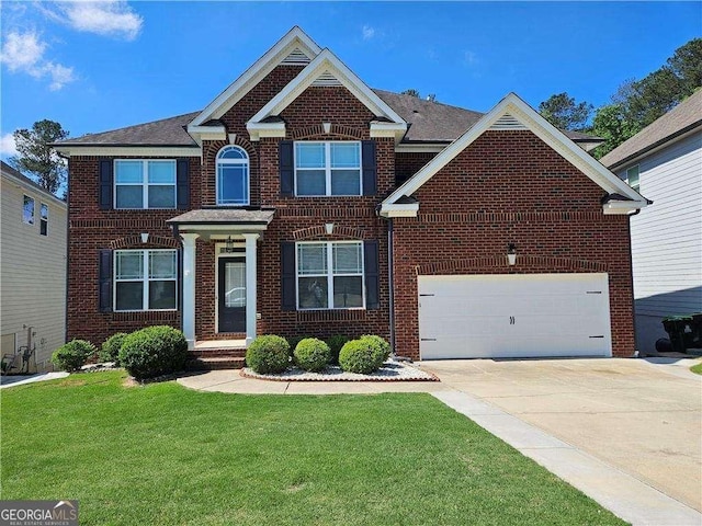 view of front of property featuring a front yard and a garage