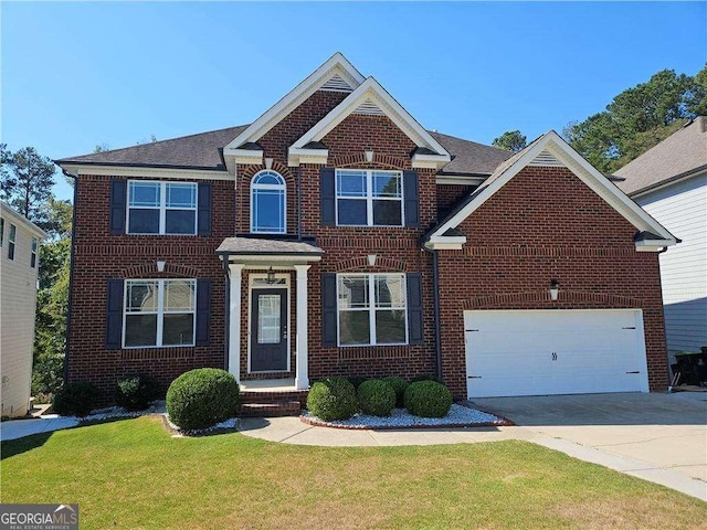 view of front of home with a garage and a front lawn